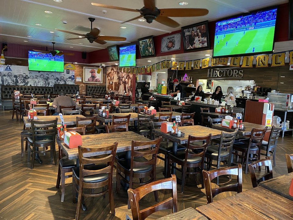 Colorful cantina tables beneath sports posters.